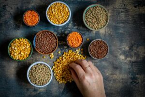 a person preparing a meal of lentils packed with vitamin b1 thiamine on a table